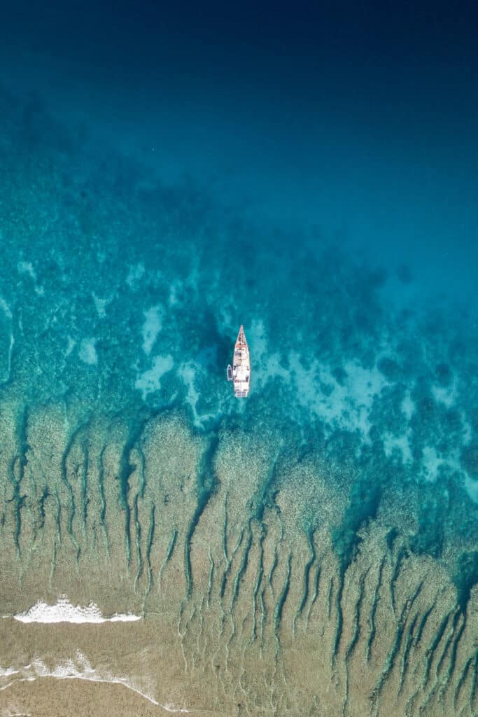 boat surrounded by reef